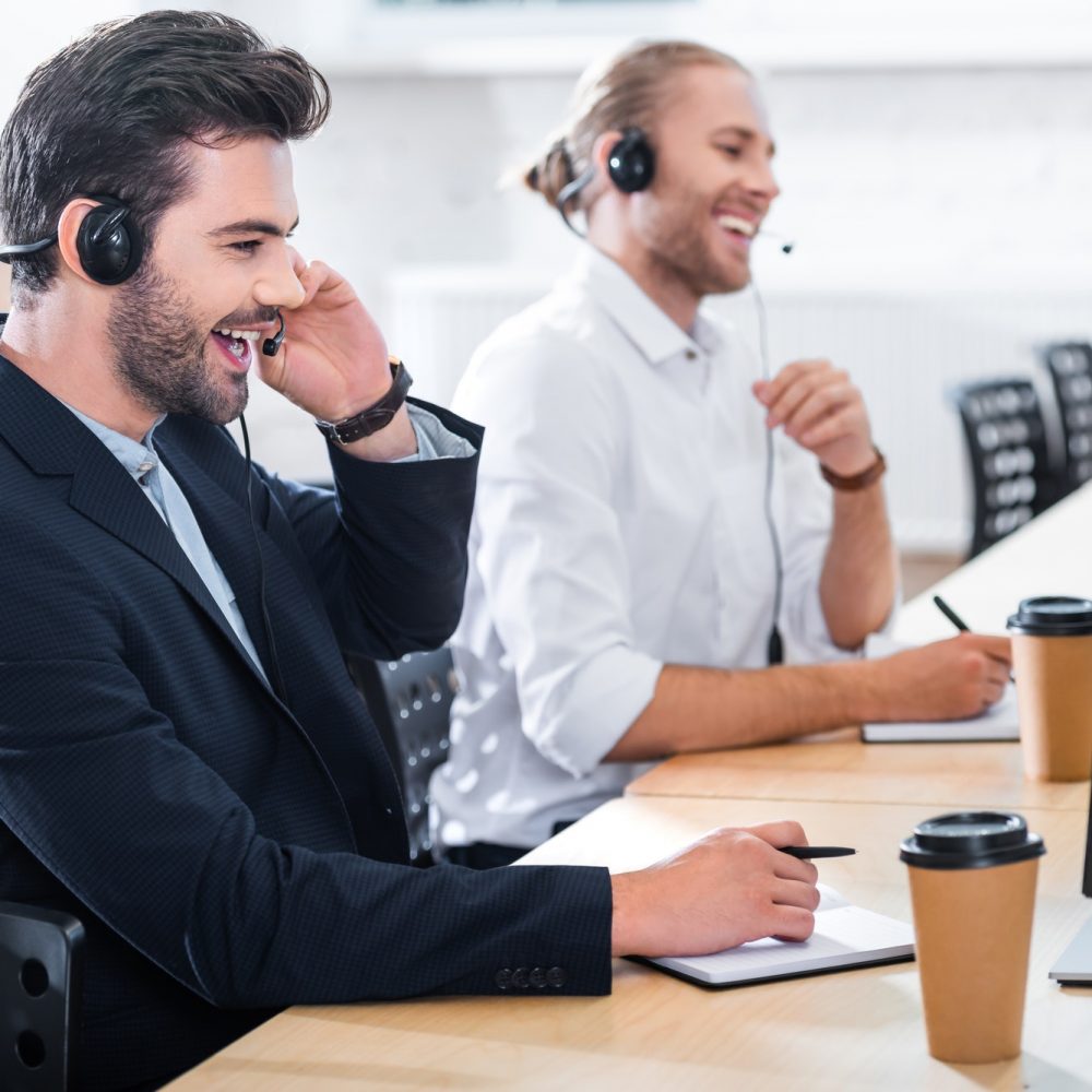 side-view-of-male-call-center-operators-in-headsets-at-workplace-in-office.jpg side-view-of-male-call-center-operators-in-headsets-at-workplace-in-office.jpg